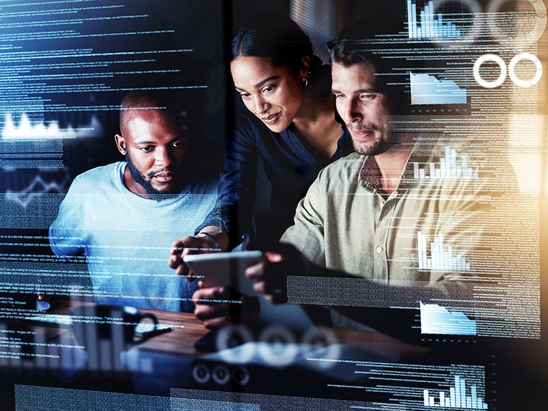 a-group-of-programmers-using-a-digital-tablet-while-working-together-on-a-computer-code-at-night