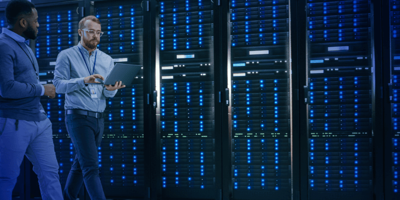 Two engineers talking in a data center